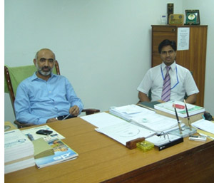 Dr. Saqib Riaz with a colleague in his office